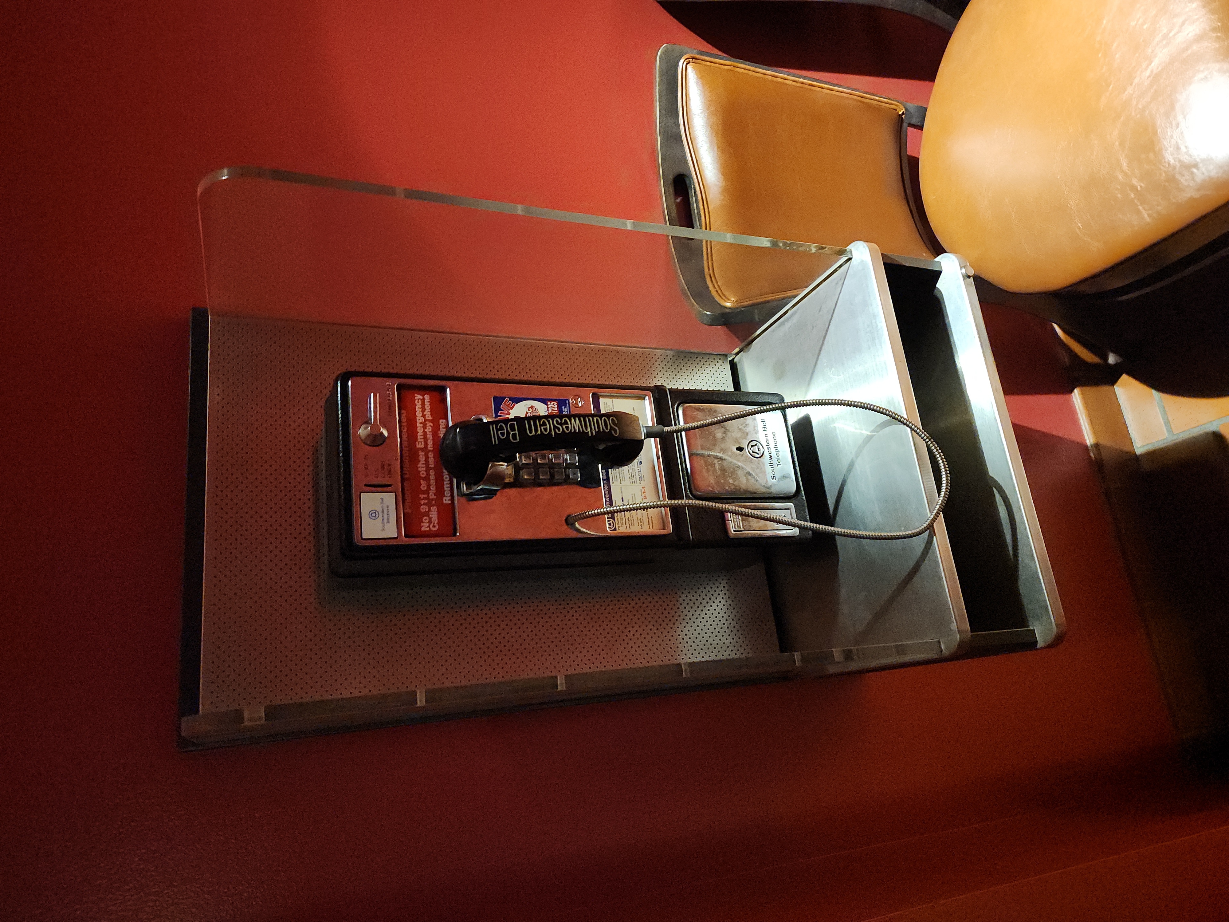Vintage Southwestern Bell Payphone on Red Wall