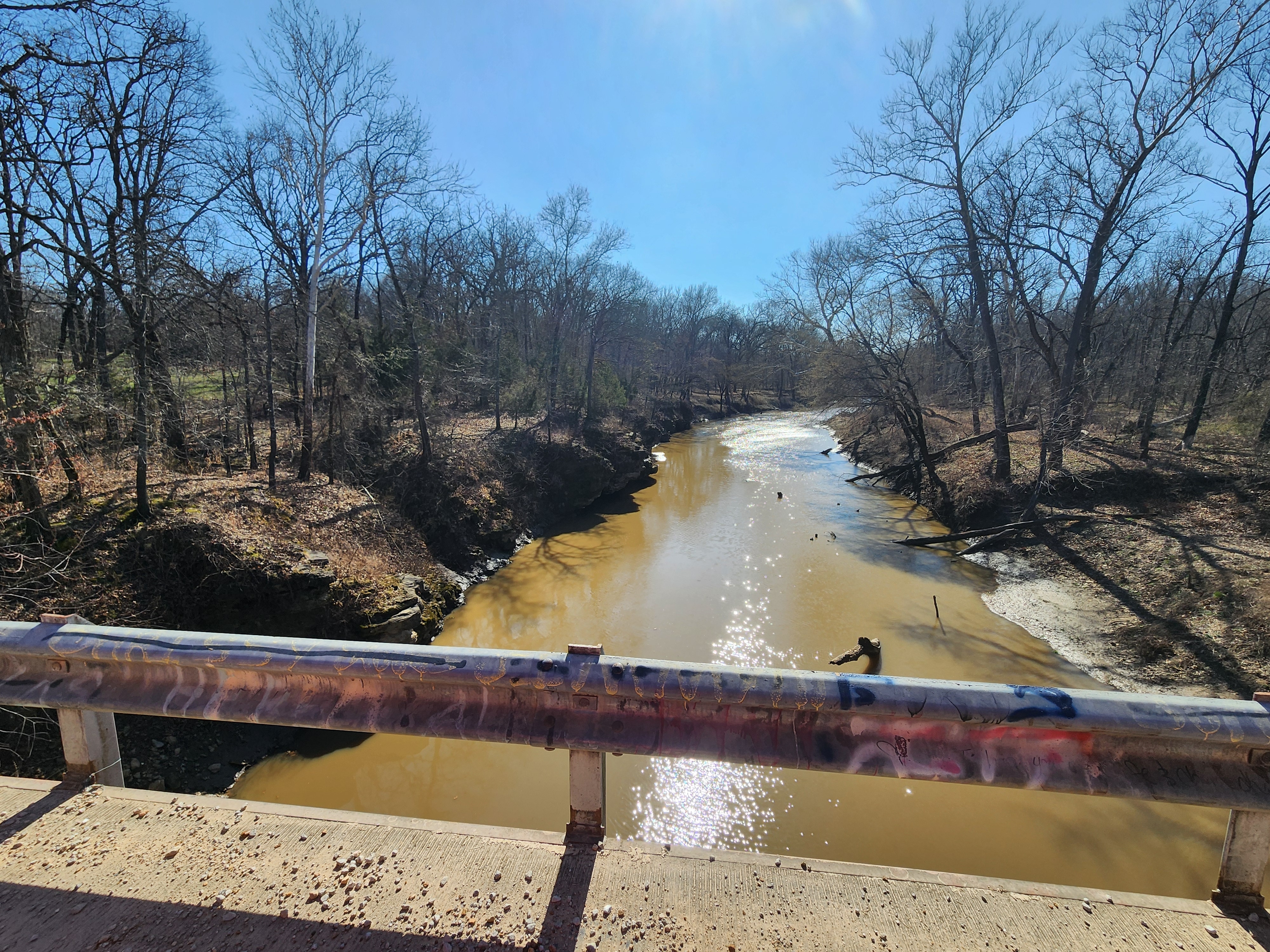 Graffiti-Tagged Guardrail on Rural Missouri Bridge