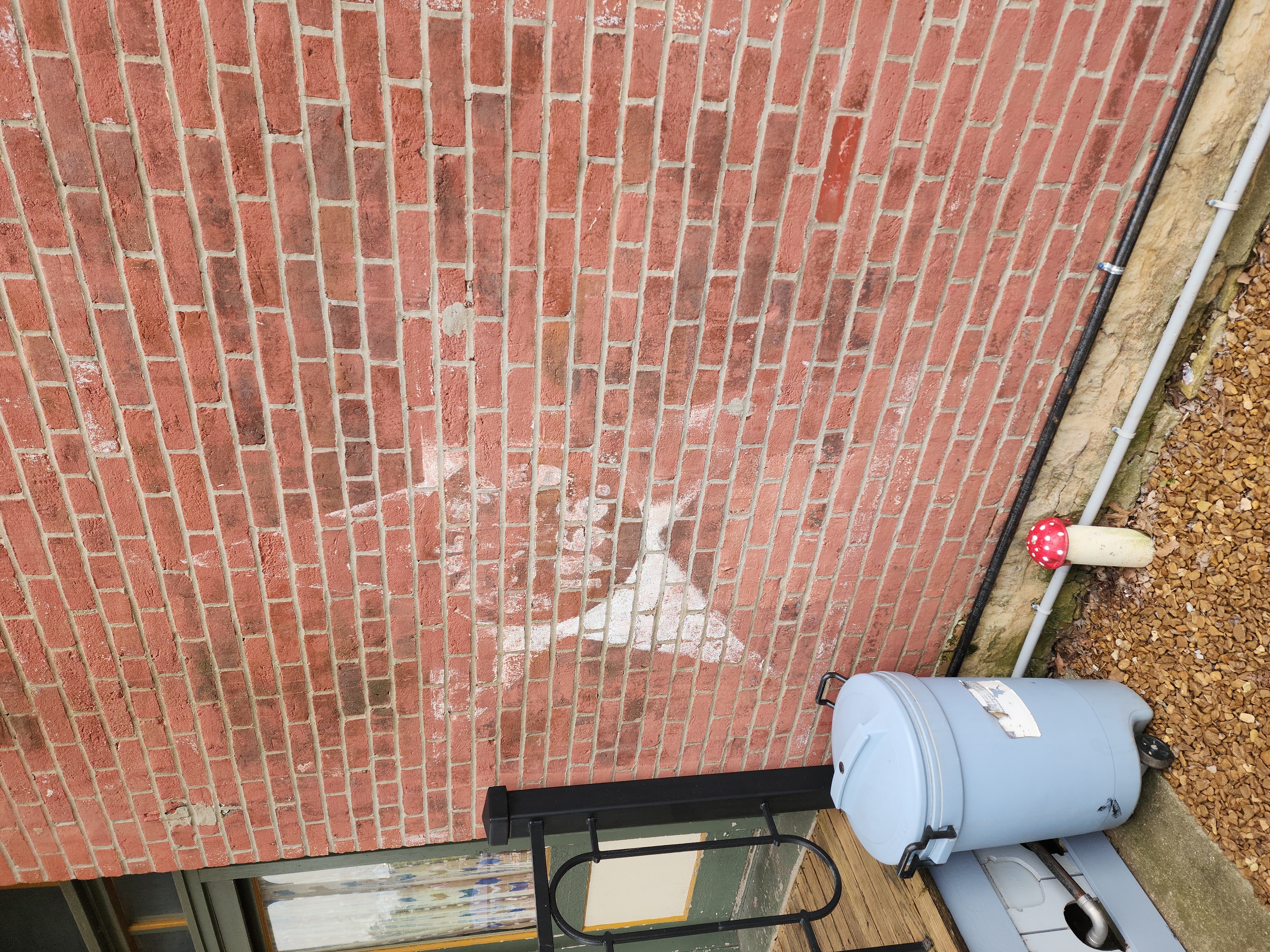 Faded White Marks on a Brick Building Wall in Fort Scott